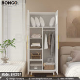 A white Jesty cupboard with gold handles, placed in a bedroom setting, part of the furniture collection BFC007 by Bongo.